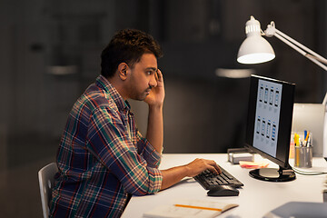 Image showing creative man with computer working at night office