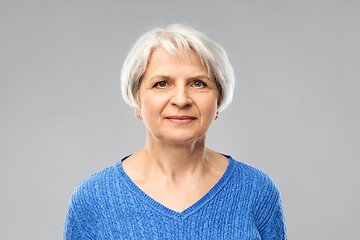 Image showing portrait of senior woman in blue sweater over grey