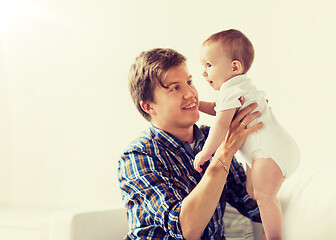 Image showing happy young father with little baby at home