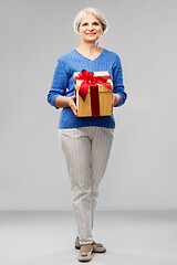 Image showing happy smiling senior woman with birthday gift box