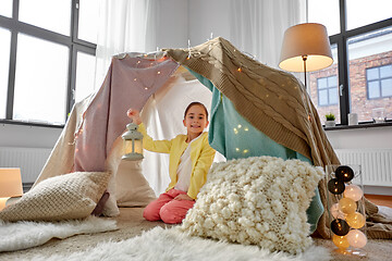 Image showing little girl with lantern in kids tent at home