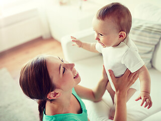 Image showing happy young mother with little baby at home