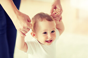 Image showing happy baby learning to walk with mother help