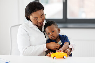 Image showing doctor with stethoscope and baby patient at clinic