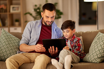 Image showing father and son listening to music on tablet pc