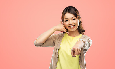 Image showing african asian making phone call gesture