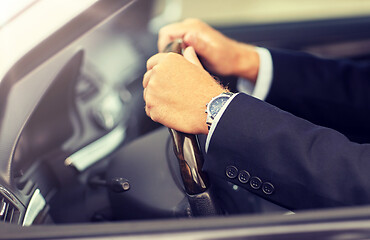 Image showing senior businessman hands driving car