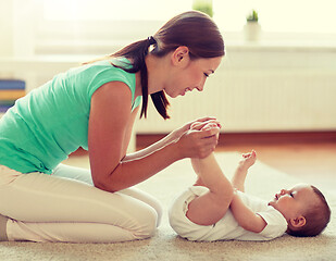 Image showing happy mother playing with baby at home