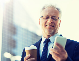 Image showing businessman with smartphone and coffee in city