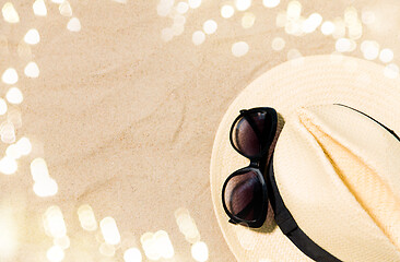 Image showing straw hat and sunglasses on beach sand