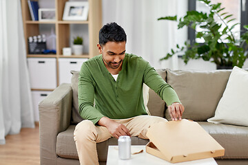 Image showing indian man looking inside of takeaway pizza box