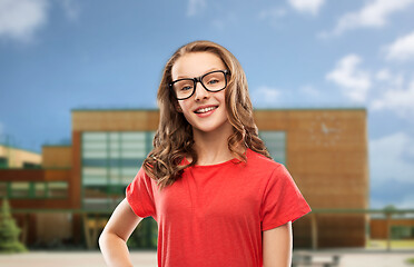 Image showing smiling student girl in glasses over school