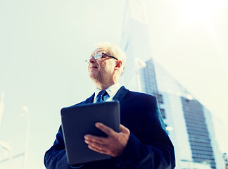 Image showing senior businessman with tablet pc on city street