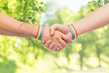 Image showing hands with gay pride wristbands make handshake