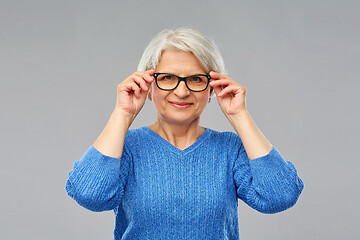 Image showing portrait of senior woman in glasses over grey