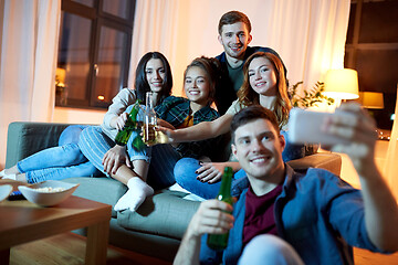 Image showing happy friends taking selfie by smartphone at home