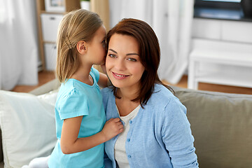 Image showing daughter whispering secret to mother at home