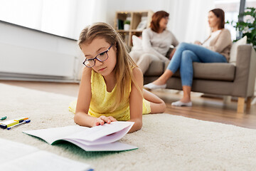 Image showing student girl with notebook lying on floor at home