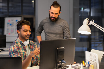 Image showing creative team with computer working late at office