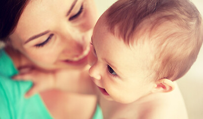 Image showing happy young mother with little baby at home