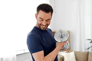 Image showing man exercising with dumbbell at home