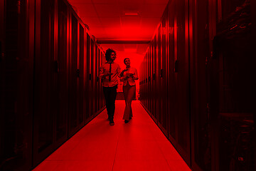 Image showing engineer showing working data center server room to female chief