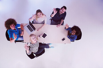 Image showing Multiethnic startup business team on meeting  top view