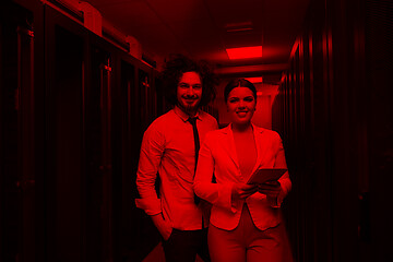 Image showing engineer showing working data center server room to female chief