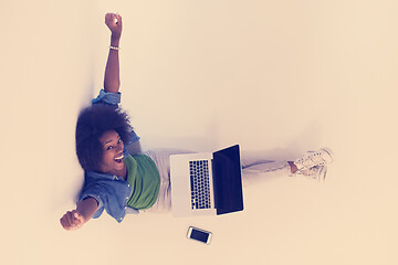 Image showing african american woman sitting on floor with laptop top view