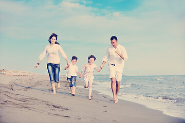 Image showing happy young family have fun on beach