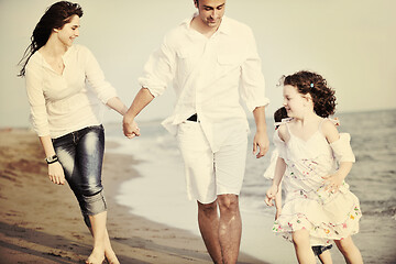 Image showing happy young family have fun on beach