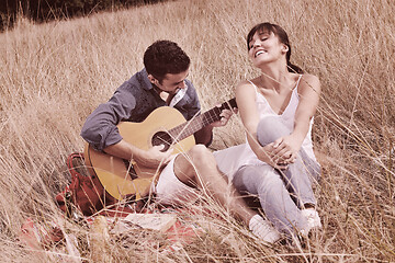 Image showing happy couple enjoying countryside picnic in long grass