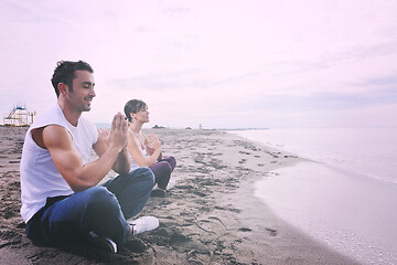 Image showing couple yoga beach