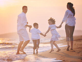 Image showing happy young family have fun on beach at sunset