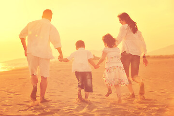 Image showing happy young family have fun on beach at sunset