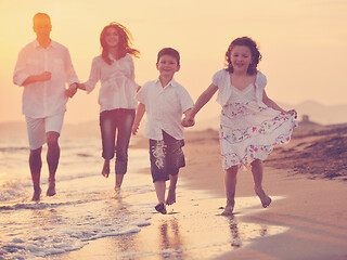 Image showing happy young family have fun on beach at sunset