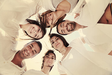 Image showing Group of happy young people in circle at beach