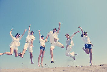 Image showing happy people group have fun and running on beach