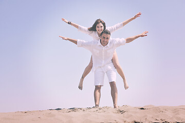 Image showing happy young couple have fun on beach