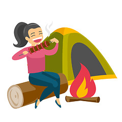 Image showing Woman sitting on log near campfire in the camping.