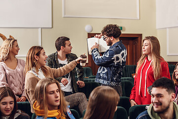 Image showing The group of cheerful happy students sitting in a lecture hall before lesson