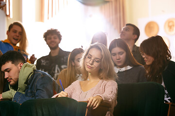 Image showing The group of cheerful happy students sitting in a lecture hall before lesson