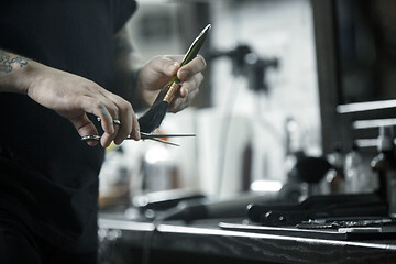 Image showing Tools for cutting beard barbershop top view. Vintage tools of barber shop on wooden background