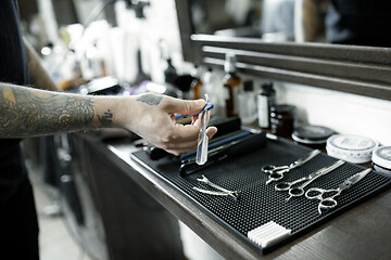 Image showing Tools for cutting beard barbershop top view. Vintage tools of barber shop on wooden background