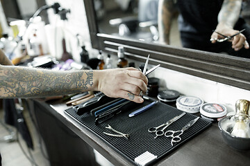 Image showing Tools for cutting beard barbershop top view. Vintage tools of barber shop on wooden background