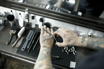 Image showing Tools for cutting beard barbershop top view. Vintage tools of barber shop on wooden background