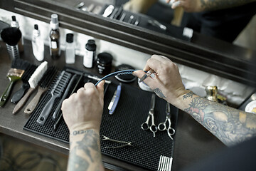 Image showing Tools for cutting beard barbershop top view. Vintage tools of barber shop on wooden background