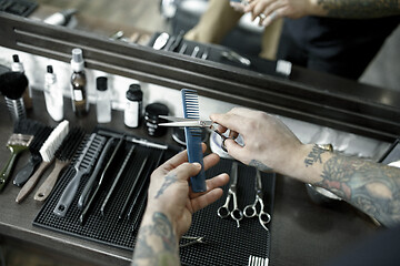 Image showing Tools for cutting beard barbershop top view. Vintage tools of barber shop on wooden background