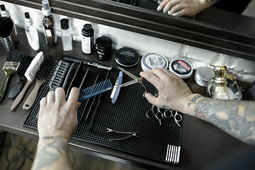 Image showing Tools for cutting beard barbershop top view. Vintage tools of barber shop on wooden background