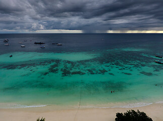 Image showing boats at beach and storm clouds